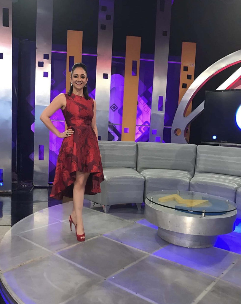 Faride Raful wearing a sleeveless red high-low dress with floral detailing, designed and made by Melina Cortes for Lalla Bee, showcasing custom design, luxury dresses, and special occasion wear by an independent luxury designer
