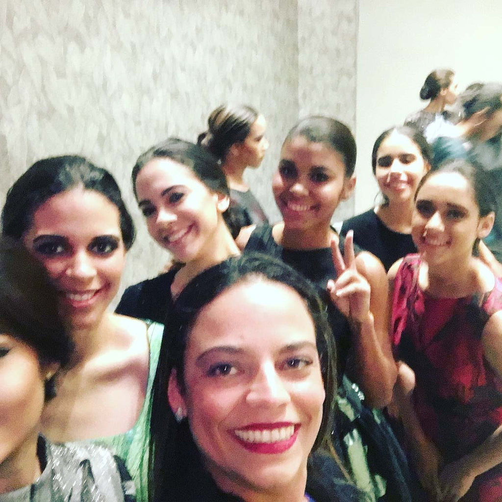 Backstage look at Republica Dominicana Fashion Week 2017 with Melina Nmili preparing designs for the runway.