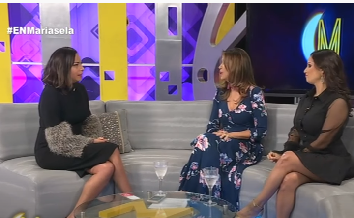 Melina Cortes-Nmili, founder of Lalla Bee, interviewed on Esta Noche Mariasela wearing a floral gown, representing her work in custom design, luxury dresses, and sustainable fashion.