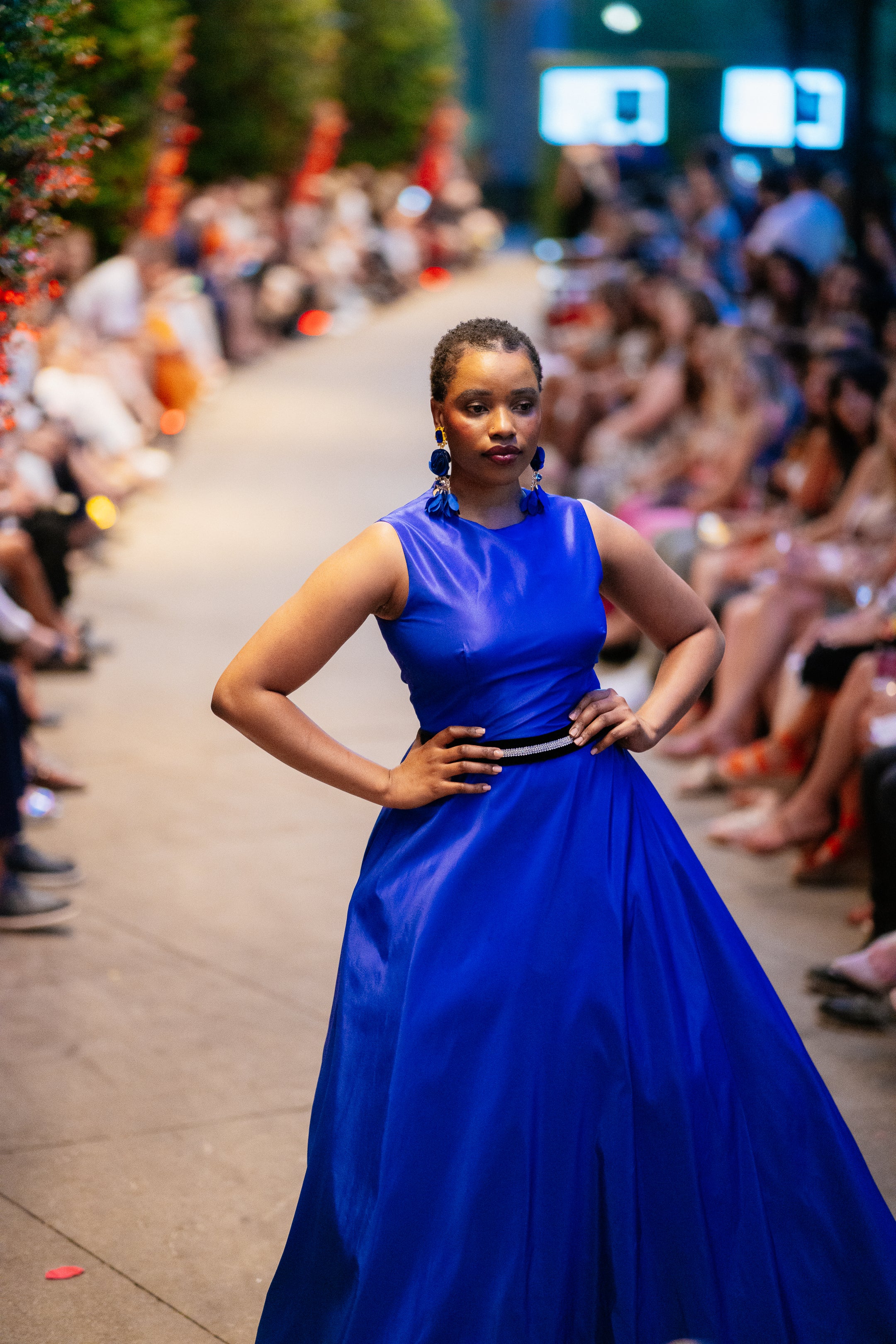 Model wearing the Lalla Bee Silk custom design gown in vibrant royal blue with a flowing skirt, perfect for galas and high-end special occasions.