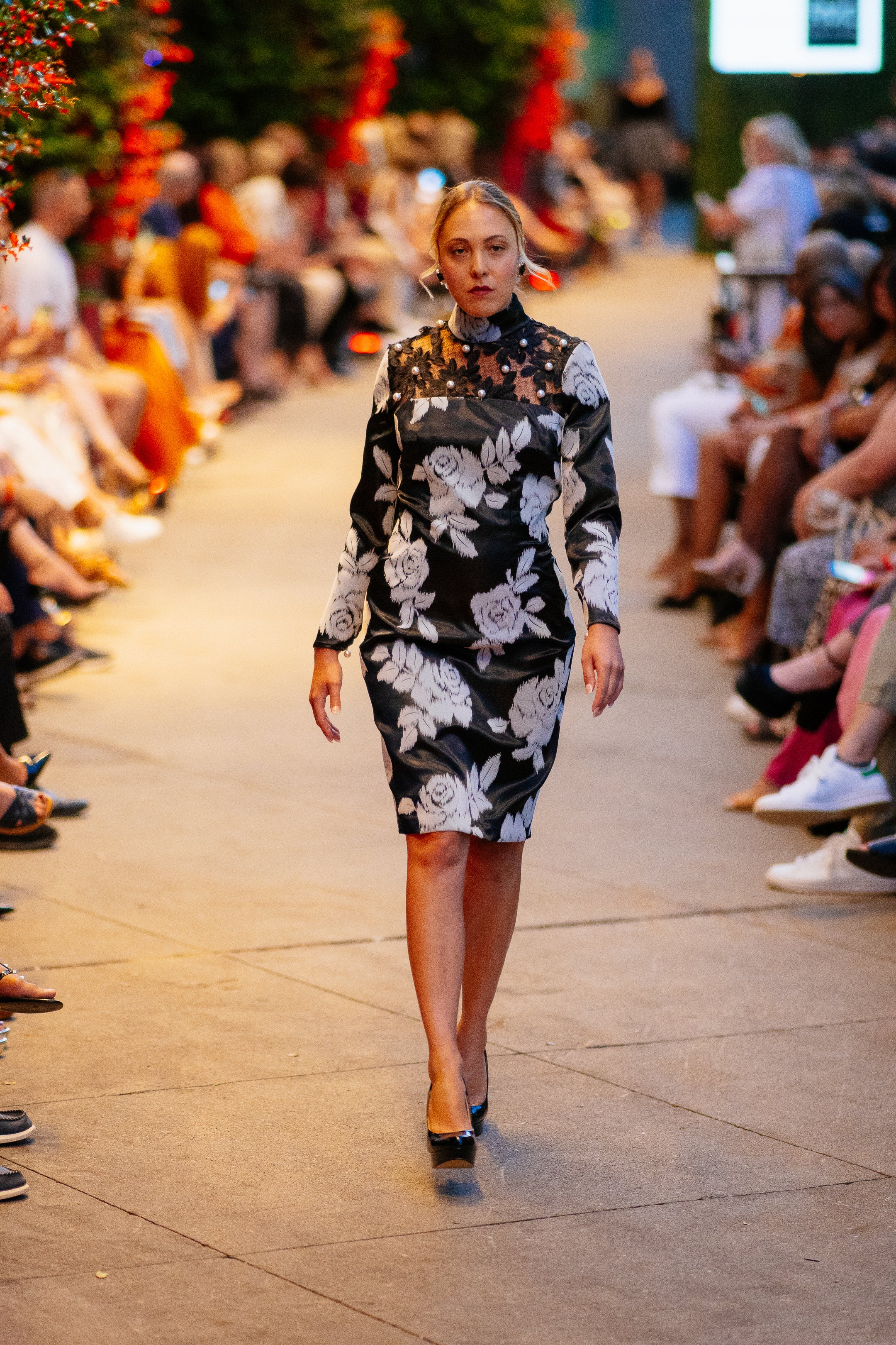 Model wearing the Lalla Bee Velvet Pearl custom design dress with a high neck, black floral velvet pattern, and long sleeves, ideal for galas and formal events.