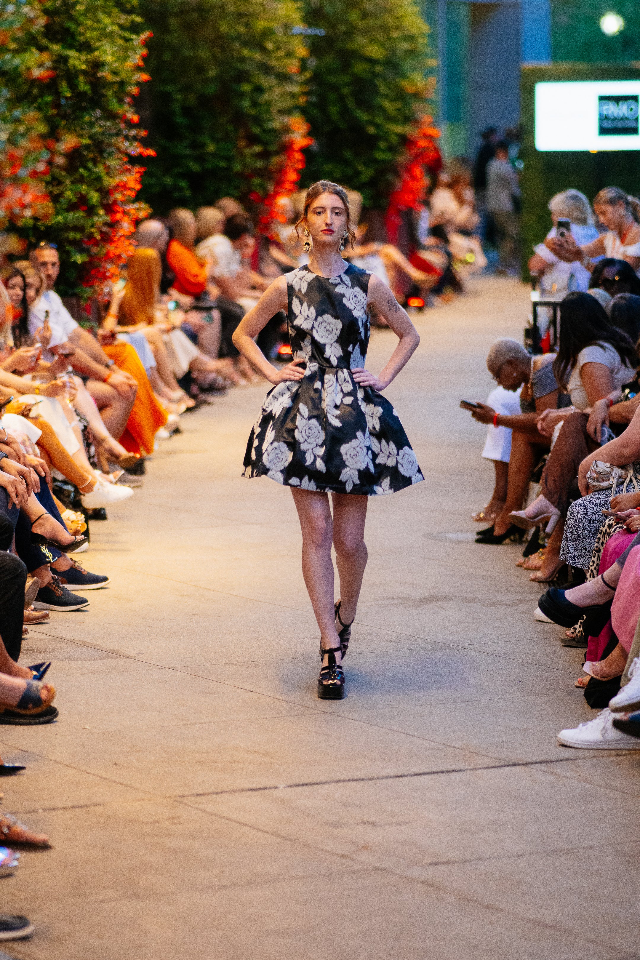 Model wearing the Lalla Bee Velvet Rose, a sleeveless black floral velvet A-line dress with a high neckline, designed for luxury events and special occasions.